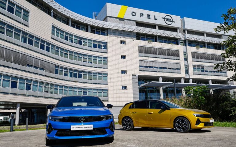 Opel Astra (car) standing in front of Opel's headquarters in Rüsselsheim.